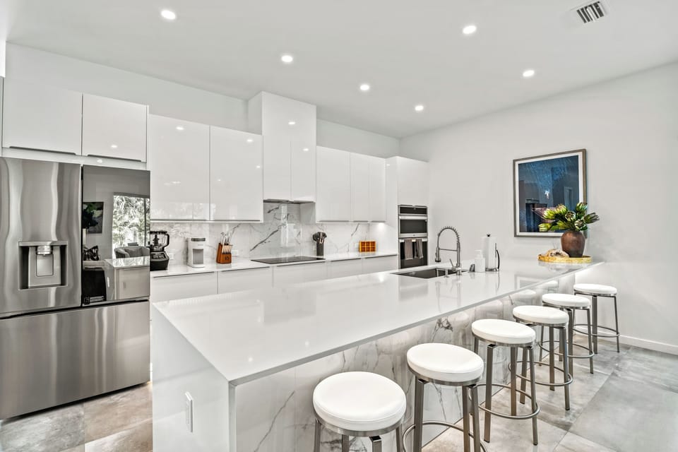 Gather around the expansive kitchen island—perfect for morning coffee, evening cocktails, and everything in between.