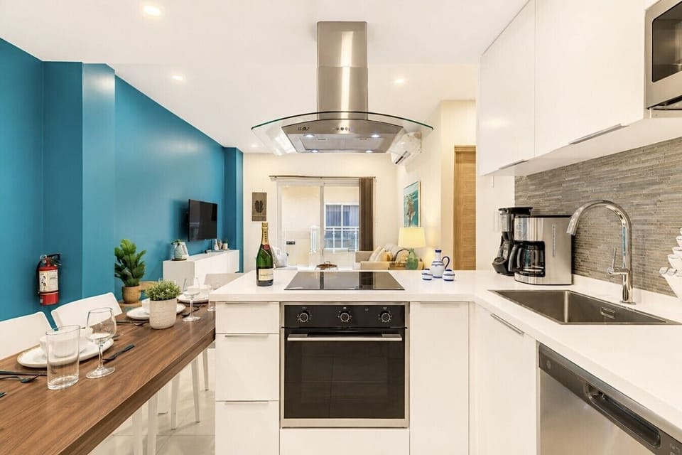 Fully equipped kitchen featuring modern appliances, cookware, essentials, and ample space for meal preparation.
