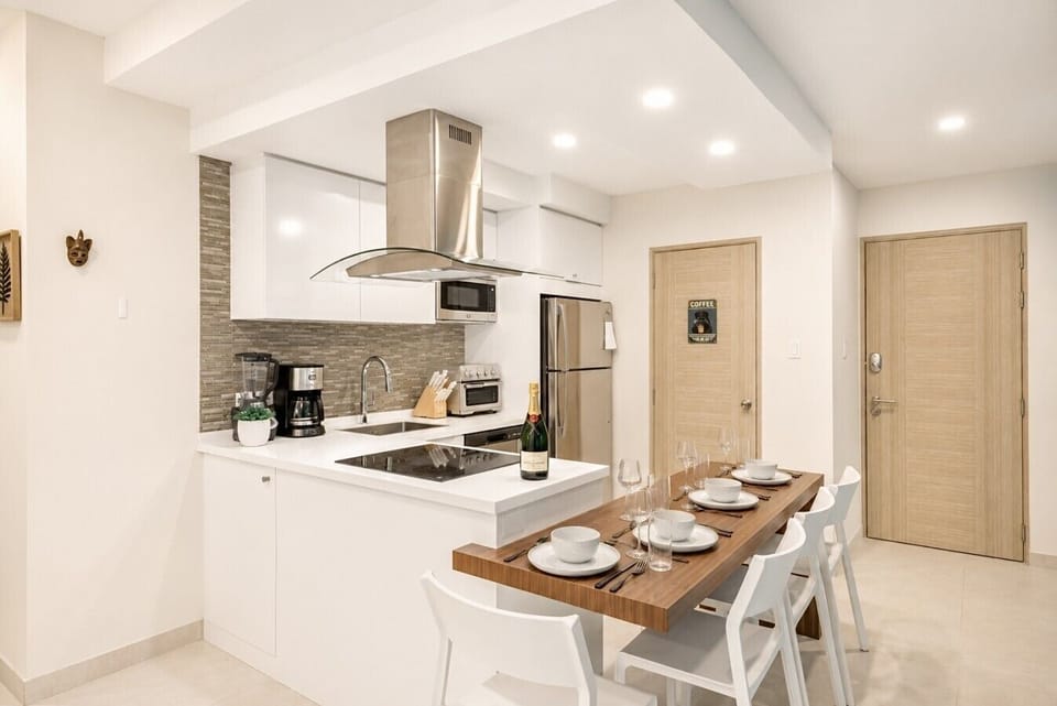 Fully equipped kitchen featuring modern appliances, cookware, essentials, and ample space for meal preparation.