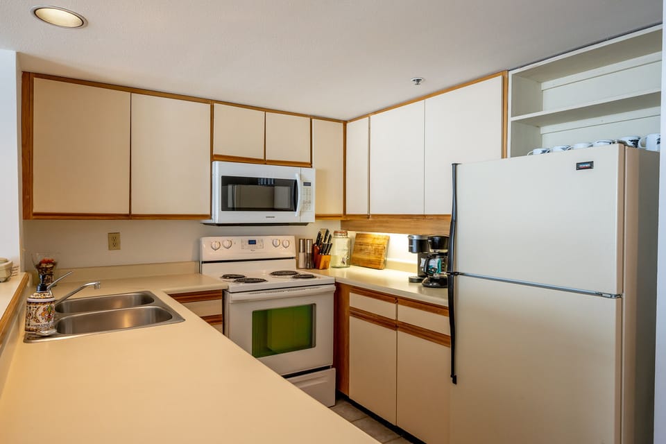 Full kitchen with all the kitchware and diningware.