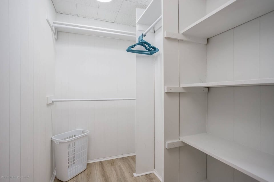 Primary bedroom with a walk-in closet