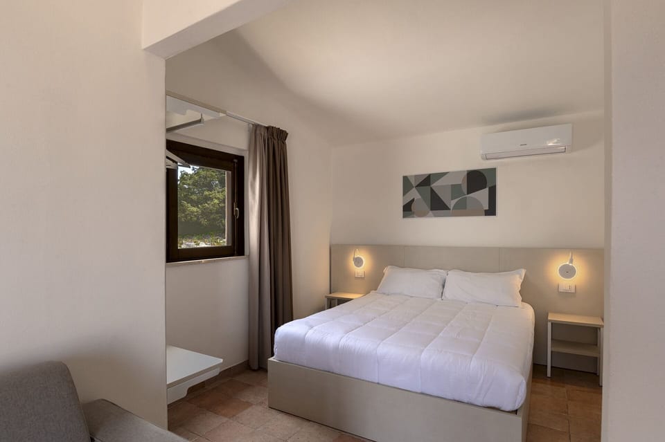 Premium bedding, desk, laptop workspace, blackout drapes