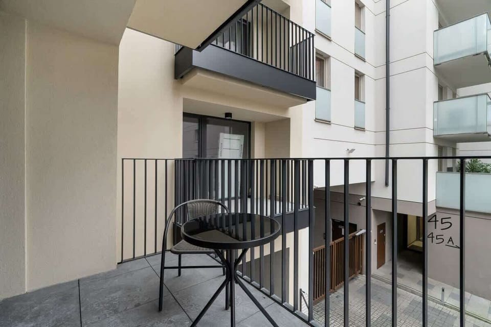 Balcony overlooking the surrounding area and with a table and chair.