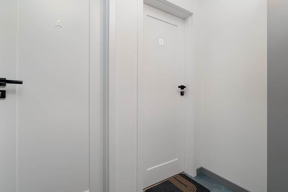 Corridor with white walls and entrance to the apartment. 