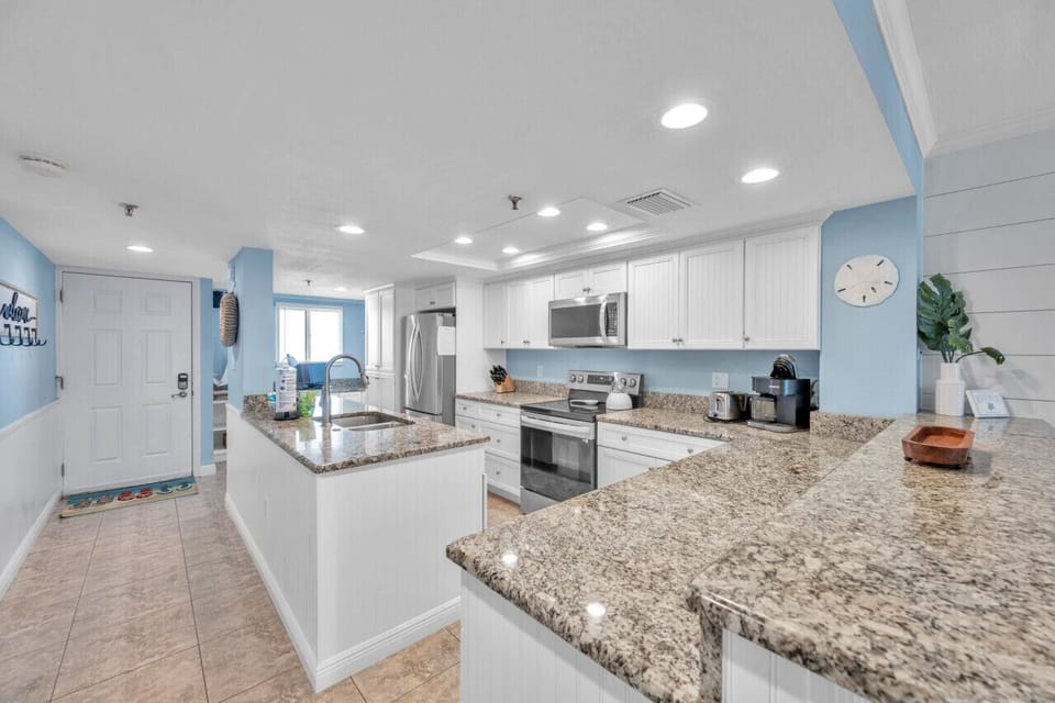 Spacious granite island offering plenty of prep room & casual seating potential.