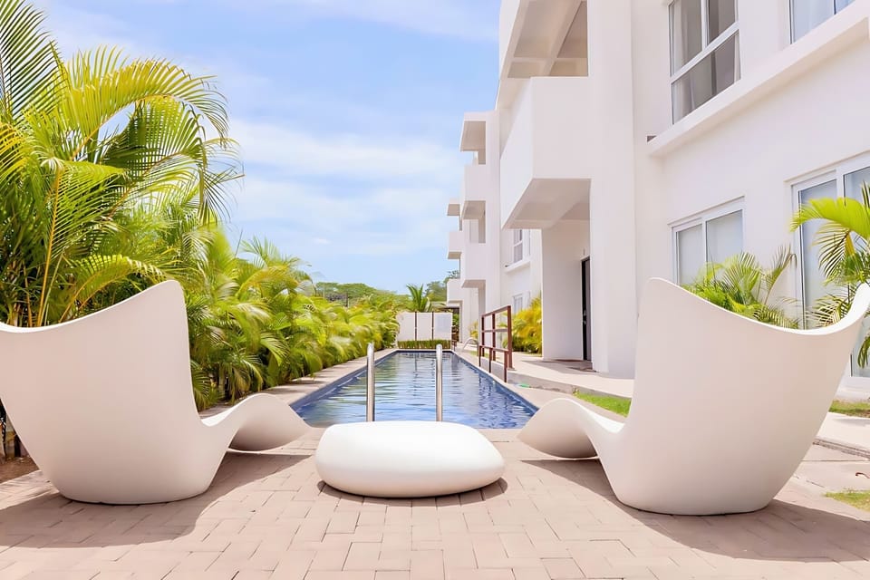 Sleek Poolside Loungers Perfect For Relaxation And Soaking In The Jaco Sun