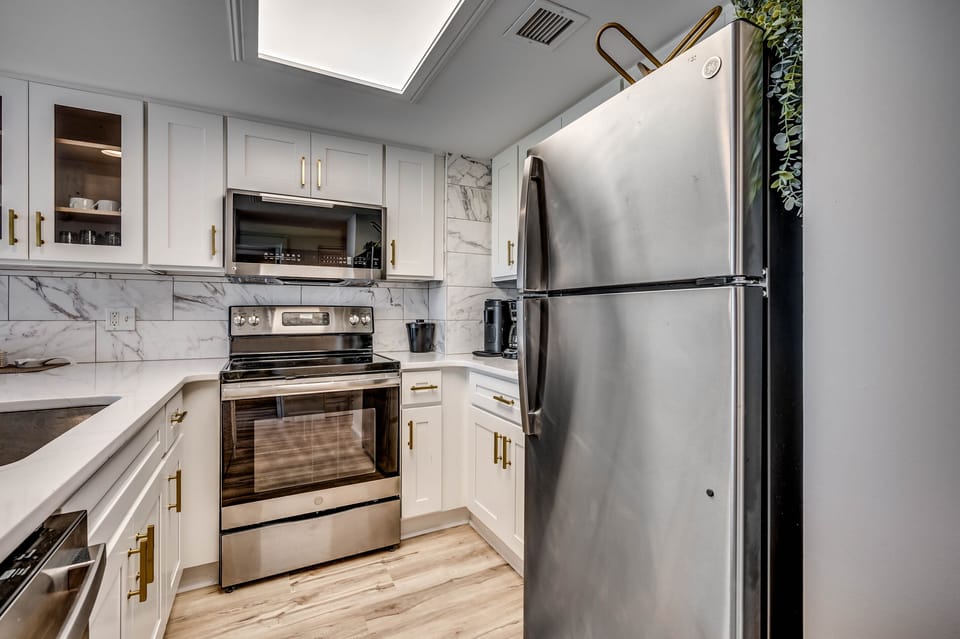 Contemporary kitchen with marble accents and stainless appliances