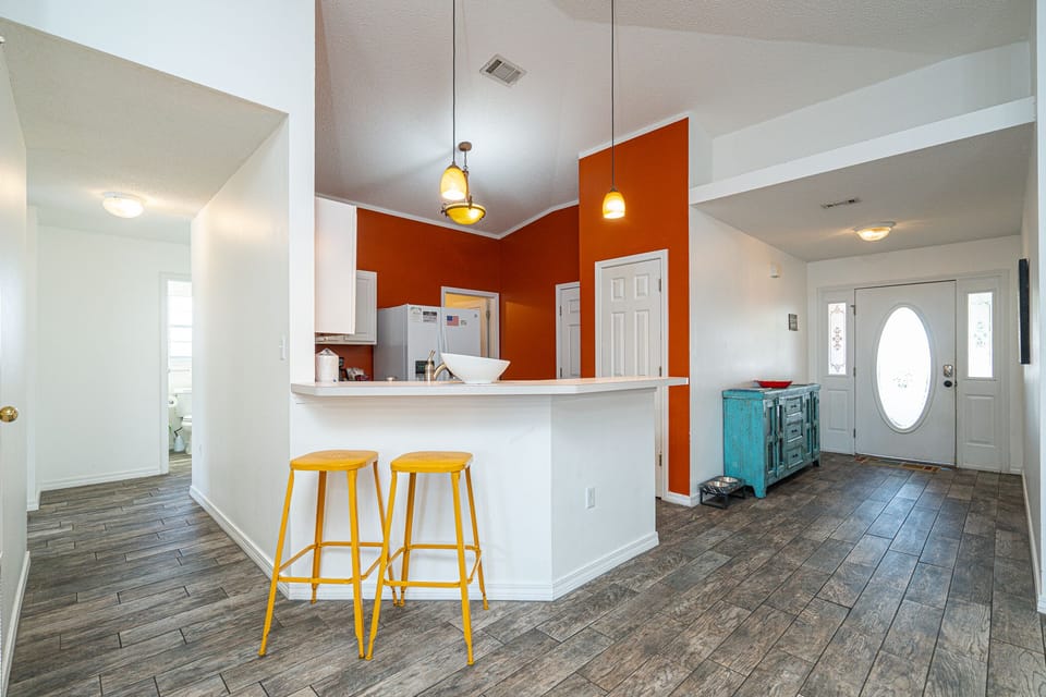 Open Concept Kitchen: Bright colors and modern decor invite you to unwind and whip up your favorites!