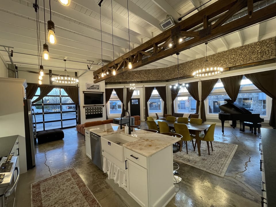 Beautiful rock, façade, and high beam ceilings along with the original showroom floor