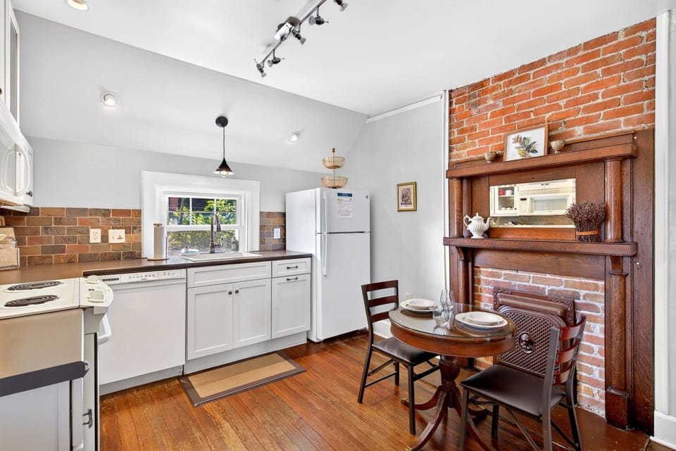 Kitchen with eat-in dining for 2, a dishwasher & a standard drip-style coffeemaker. Note: The fireplace is decorative and not functional.