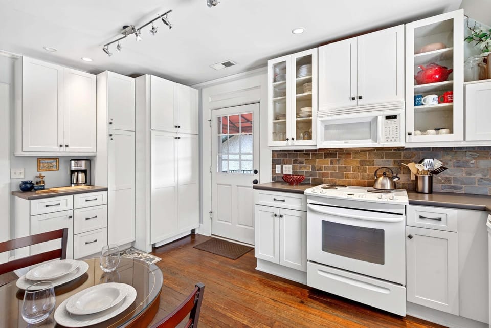 Kitchen with eat-in dining for 2, a dishwasher, and a standard drip-style coffeemaker. Note: The washer & dryer are located behind the cabinet (right) in the kitchen.