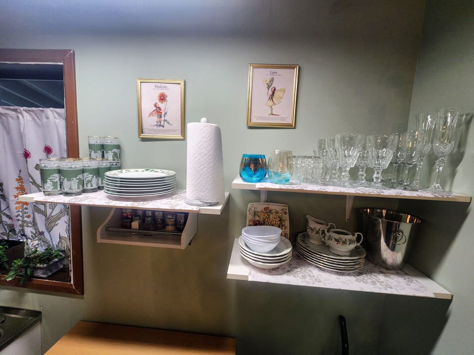kitchen is well stocked with dishes and utensils, cooking spices, and storage.