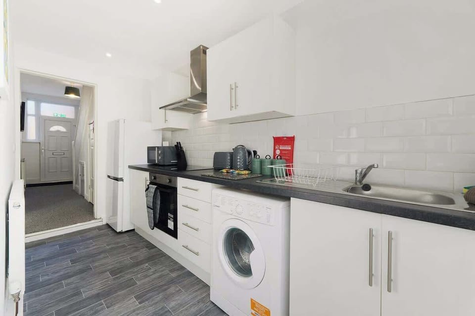 Kitchen equipped with all essentials, including a washer & dryer, oven, fridge and full cookware set.