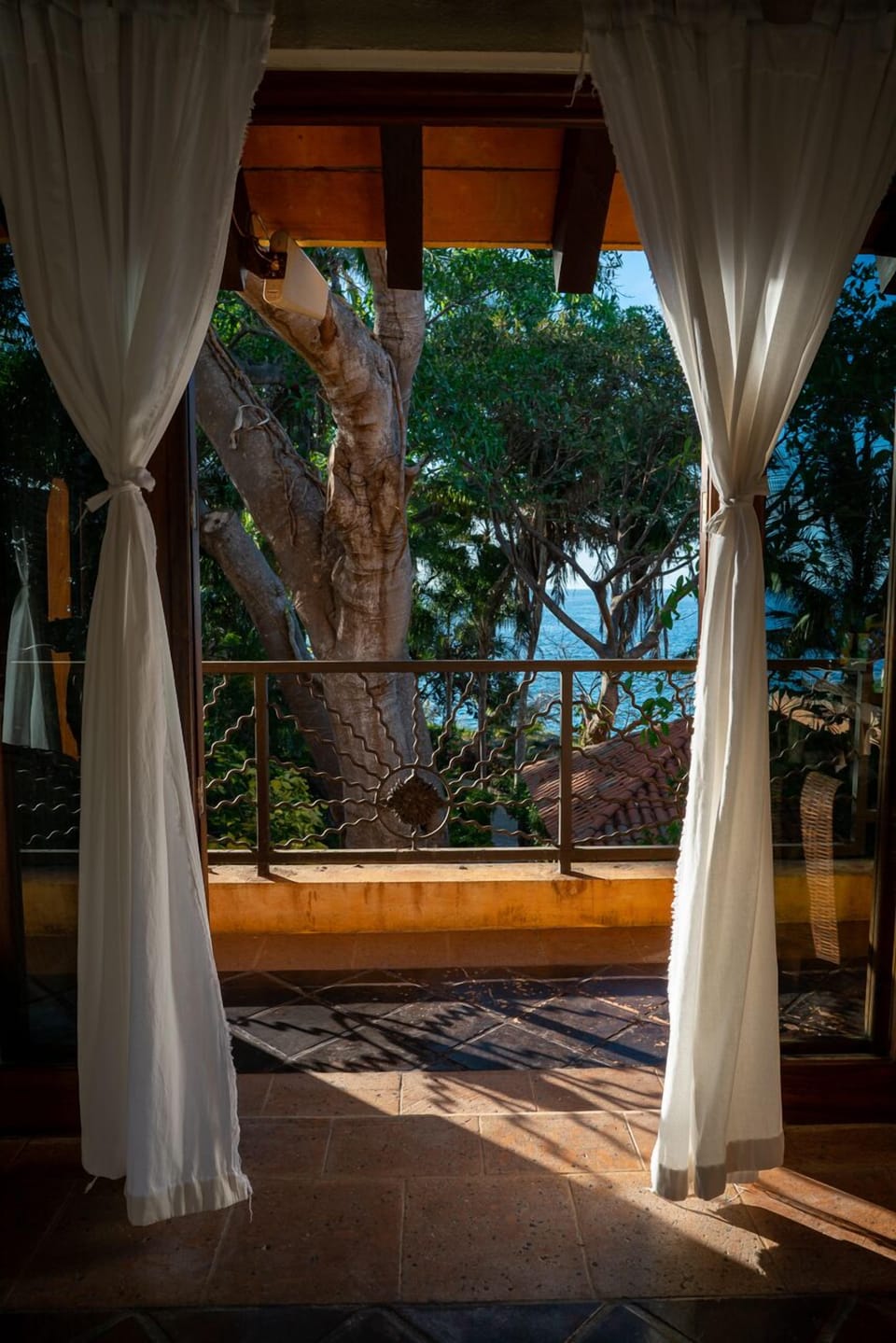 Bedroom door open to sea and afternoon sun