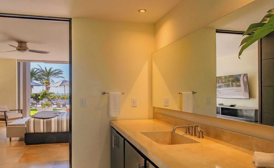 Modern bathroom with sleek stone finishes and a walk-in shower.