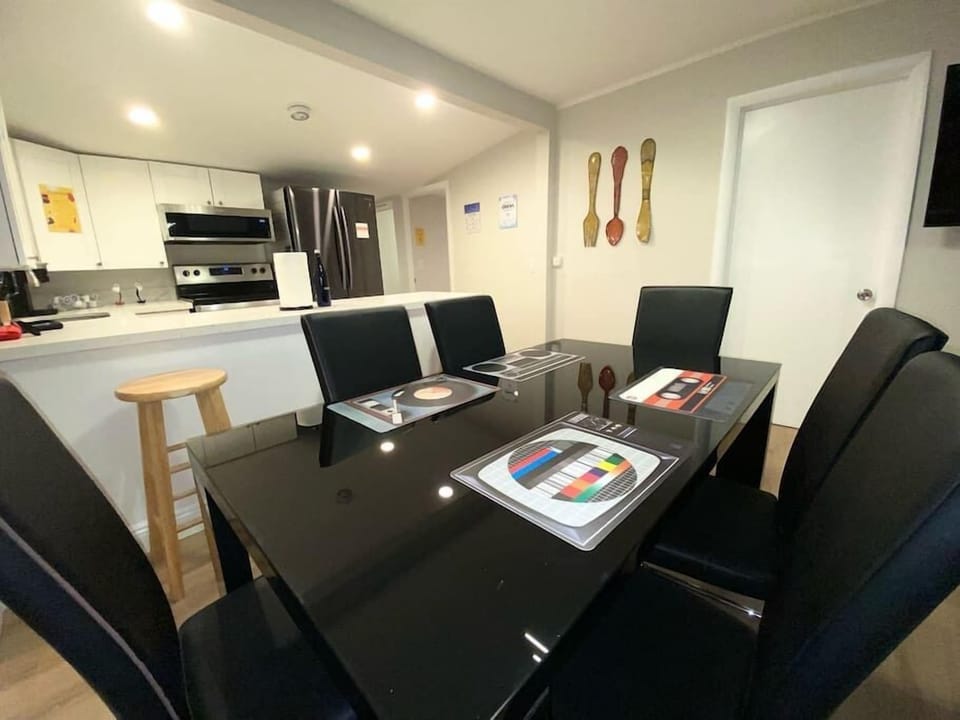 Welcome to our chic dining space— a sleek glass top table, seating 6 with ease. Urban art and graffiti-themed decor add flair, creating a vibrant atmosphere for shared meals and lively conversations. A modern feast for the eyes and senses. 