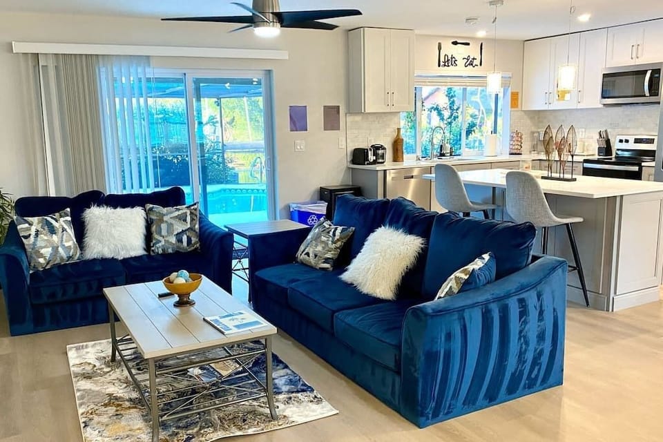 Experience comfort and luxury in our modern living room! Sink into plush sofas, bask in natural sunlight through large windows, and enjoy entertainment on our 75-inch smart TV. With direct access to the pool, relaxation awaits at your fingertips.