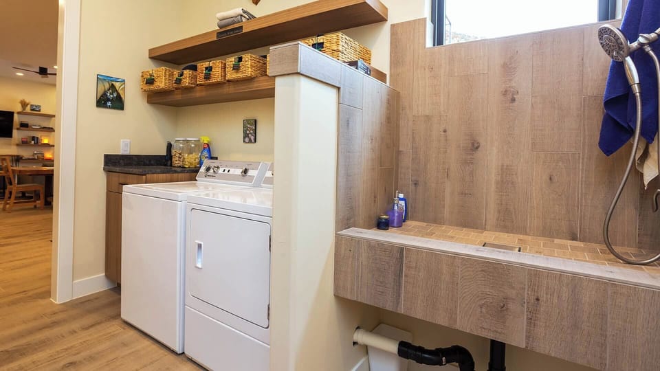 Clean up is a breeze at Desert Willow! The laundry room not only features full-capacity washer & dyer, but also a dog washing station.