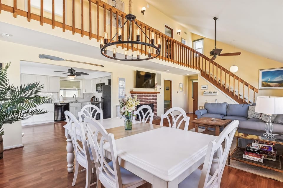 You'll love the open layout where dining, kitchen, and living spaces flow together under soaring ceilings with warm wood accents, inviting natural light, and a cozy loft above for peaceful retreat.