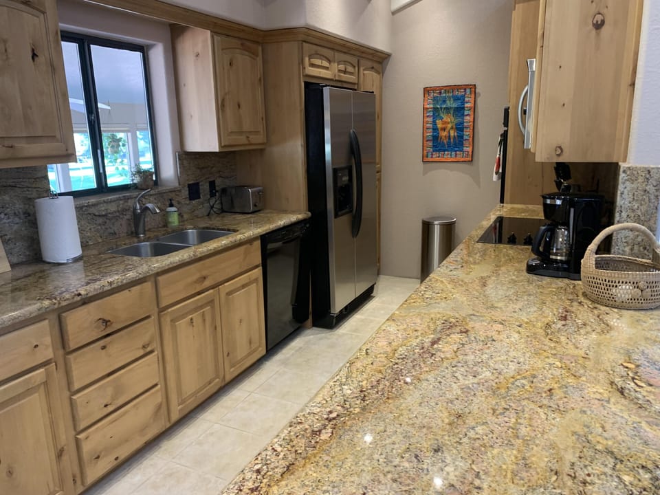 Fully equipped kitchen with views of the fairway.