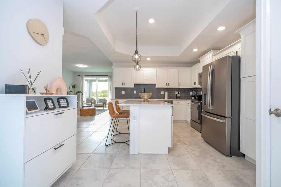 The fully equipped kitchen features modern appliances, sleek cabinetry, and all essential cookware and utensils, making it perfect for preparing meals with ease.
