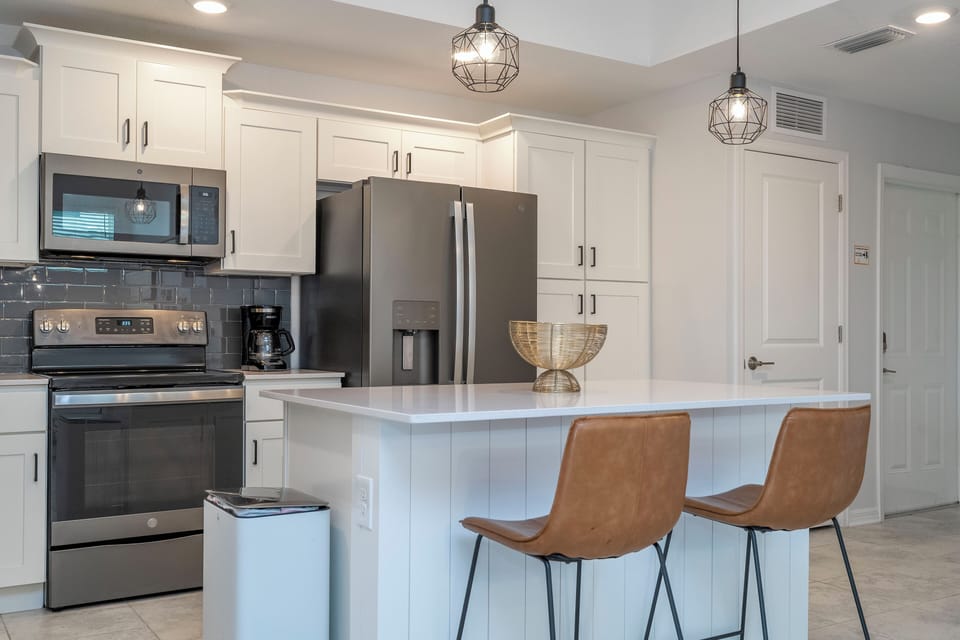 The fully equipped kitchen features modern appliances, sleek cabinetry, and all essential cookware and utensils, making it perfect for preparing meals with ease.