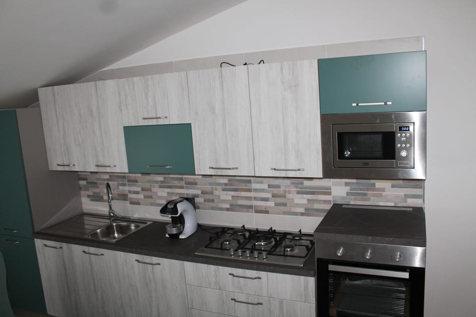 Deluxe Condo | Private kitchen | Espresso maker, electric kettle, dining tables