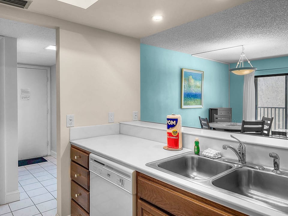 Kitchen with wood cabinets, sink, and coastal décor accents