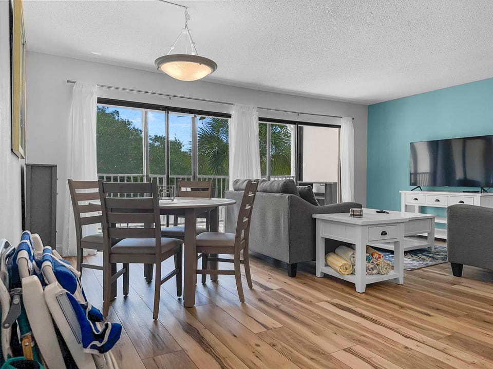 Dining area with table and chairs adjacent to the balcony