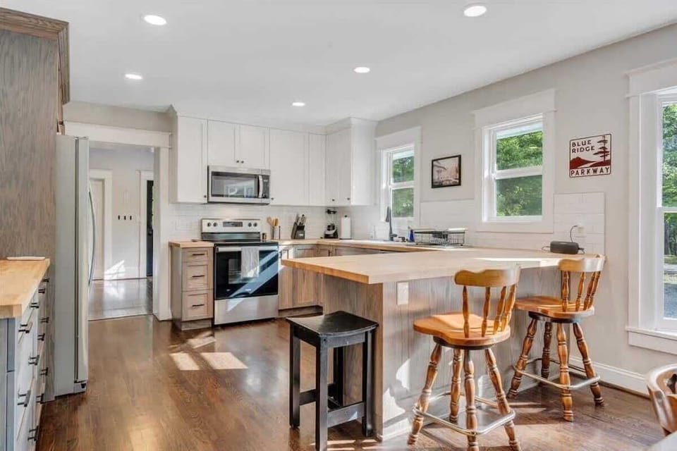 Kitchen with butcher block island and stainless steel appliances