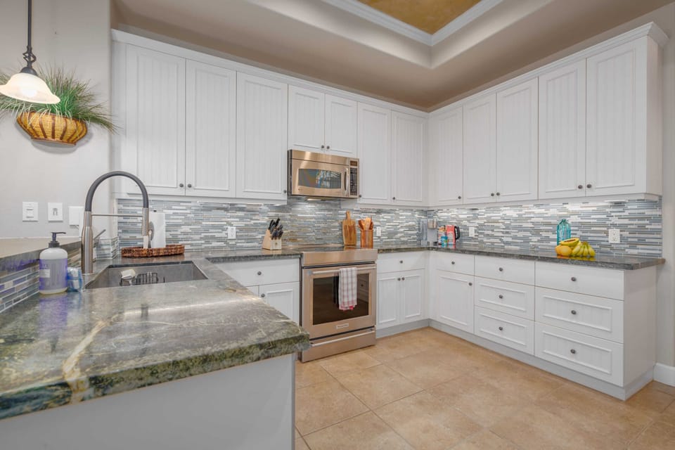 Dishwasher, microwave, electric range and oven, and large refrigerator.
