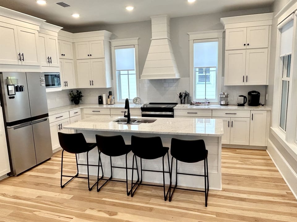 Your fully-equipped gourmet kitchen features marble countertops, stainless steel appliances, and an island with seating for four—perfect for culinary adventures.
