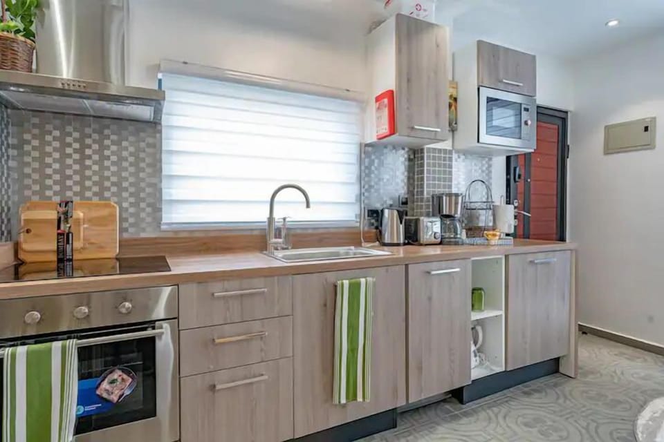 Fully equipped modern kitchen with coffee station, washer/dryer, refrigerator