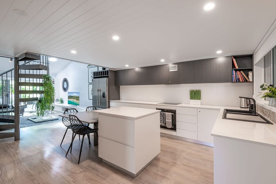 Modern, open kitchen with dining space that seamlessly extends into living area
