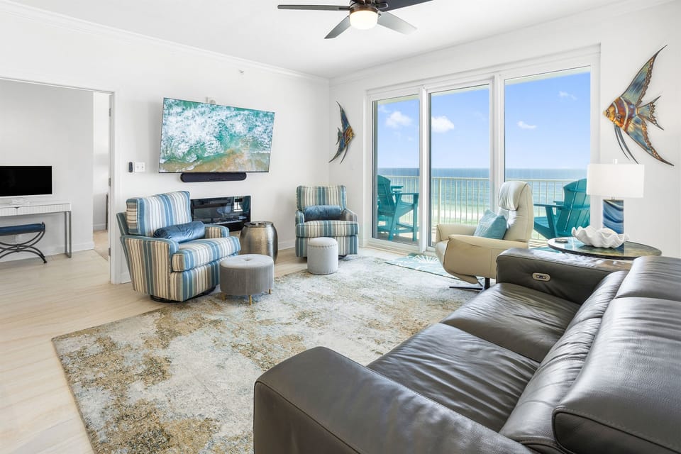 Your oceanfront living room awaits with plush seating, coastal décor, and stunning sea views through expansive windows.