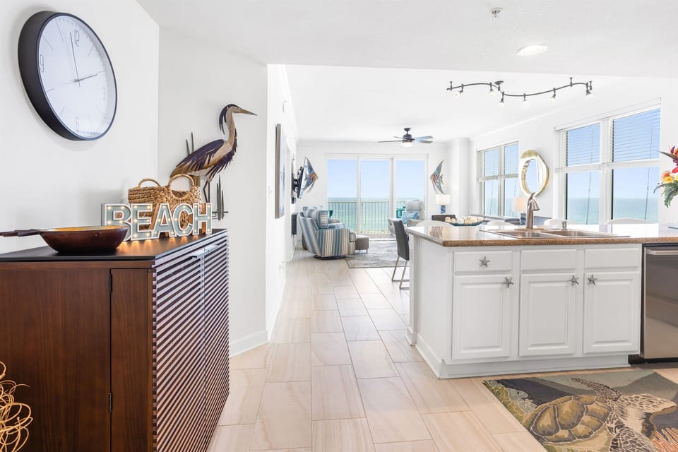Unwind in your bright coastal kitchen with ocean views stretching beyond the living space, perfect for morning coffee or preparing seaside meals.
