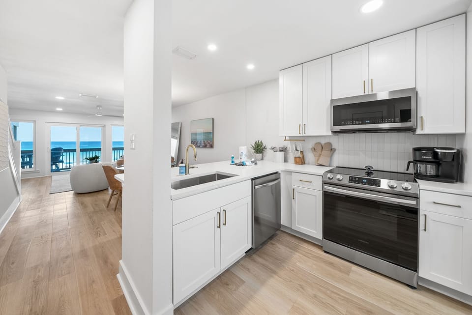 Your fully-equipped kitchen opens to stunning ocean views, perfect for cooking while watching the waves.