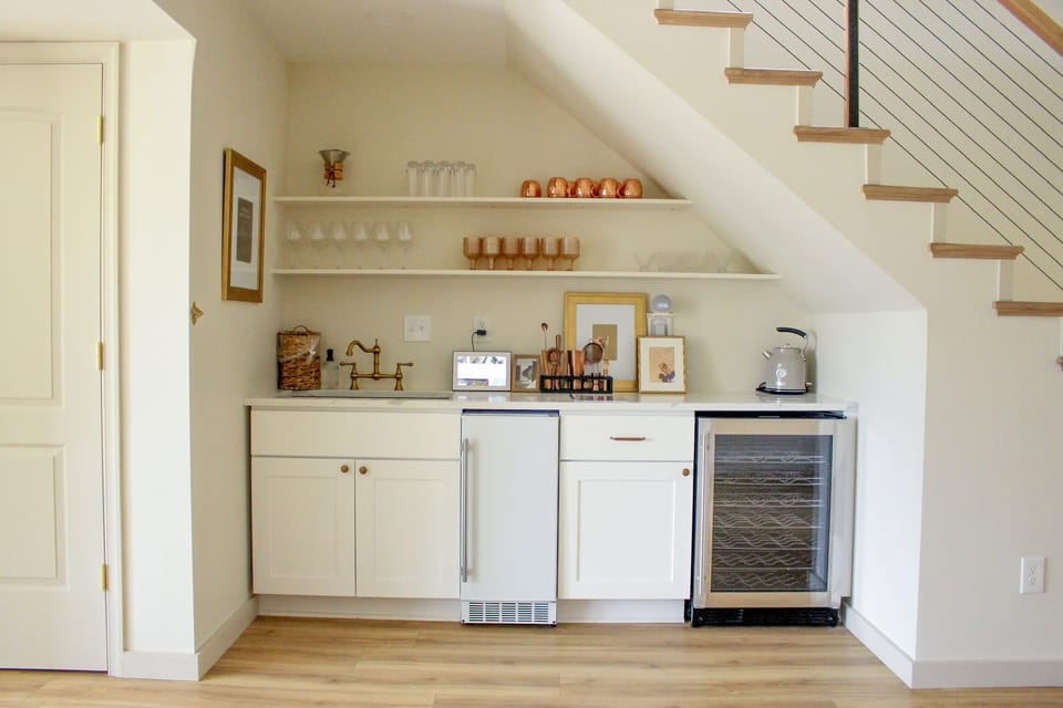 FULLY stocked wet bar with all your bartending needs! There is a wine cooler and ice maker along with a full sized sink.
