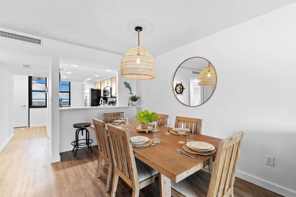 Spacious dining area, seats six plus bar seating open to living room and kitchen