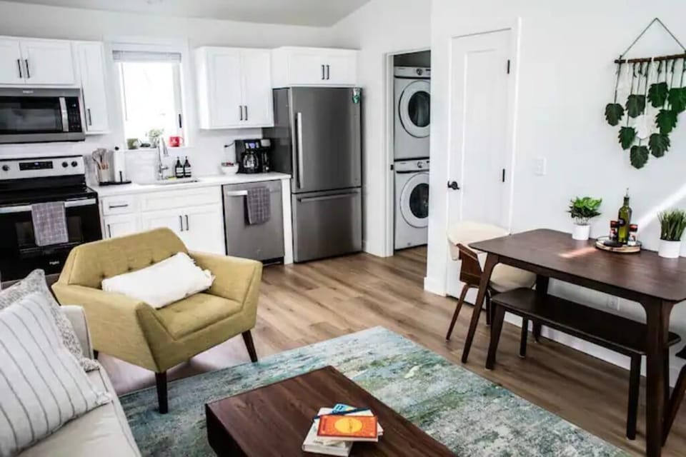 Here is our fully equipped kitchen and entry to the bathroom that includes a stackable washer/dryer for you to do laundry as needed!