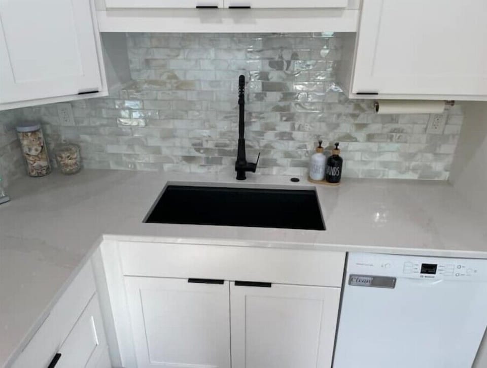 Deep sink with accessory racks, Bosch quiet dishwasher, touchless faucet.