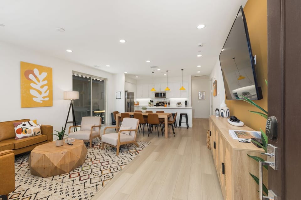Open floor plan living room area, dining and kitchen area with 75 ' Smart Tv