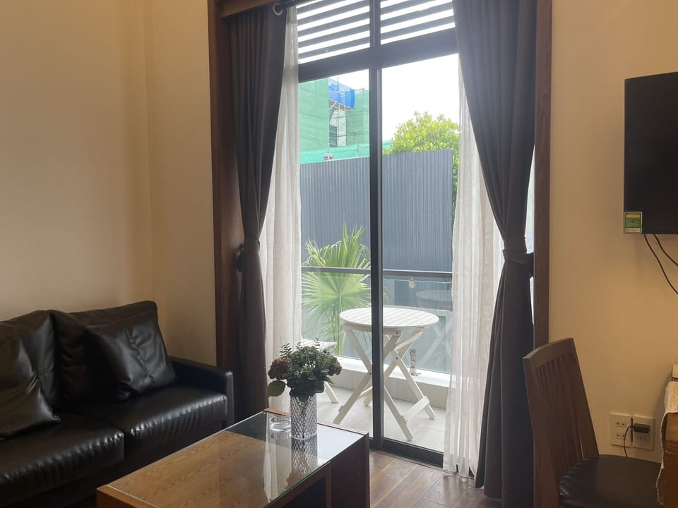 Basic Apartment, Pool View | Living area | Flat-screen TV