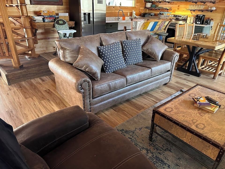 Sink into this comfortable leather sofa perfectly positioned for relaxing with a book.