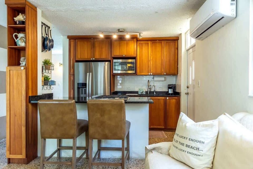 Stainless steel appliances, island, bar stools.  Fridge/Freezer w/ ice maker, microwave, gas range & oven.  Coffee maker, pots & pans, plates, bowls, glassware, wine glasses and all the other kitchen accessories to prepare fabulous meals.  