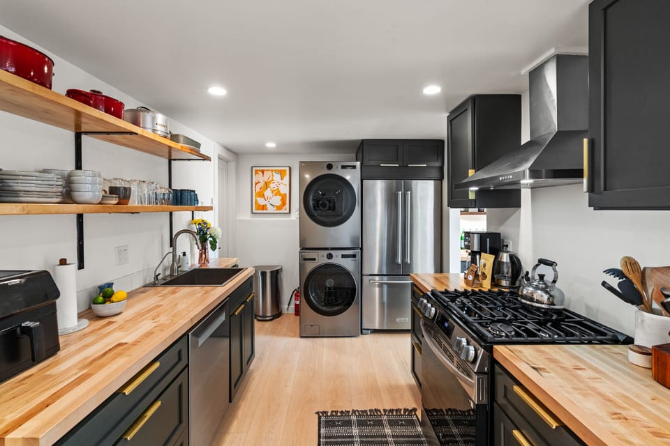 Full kitchen with new, modern appliances and stocked with all you need for meal prep and entertaining.