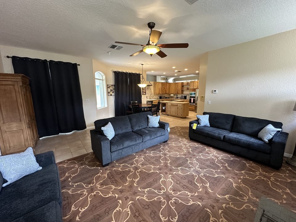 Living Room with 2 sofa beds connected to dining area and kitchen