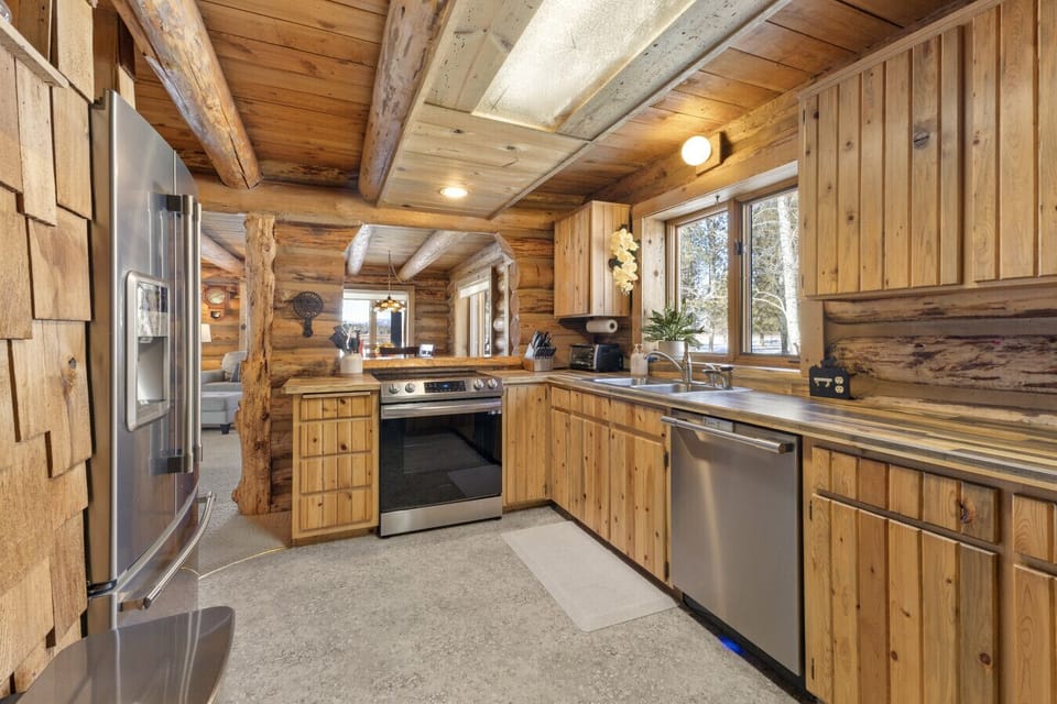Stainless range, dishwasher, and a well-equipped kitchen for cooking any size meal