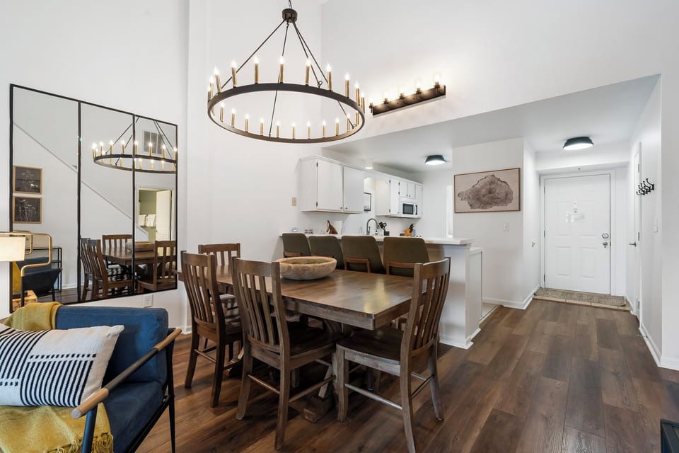 Dining room with chairs and bench seating, along with breakfast bar.