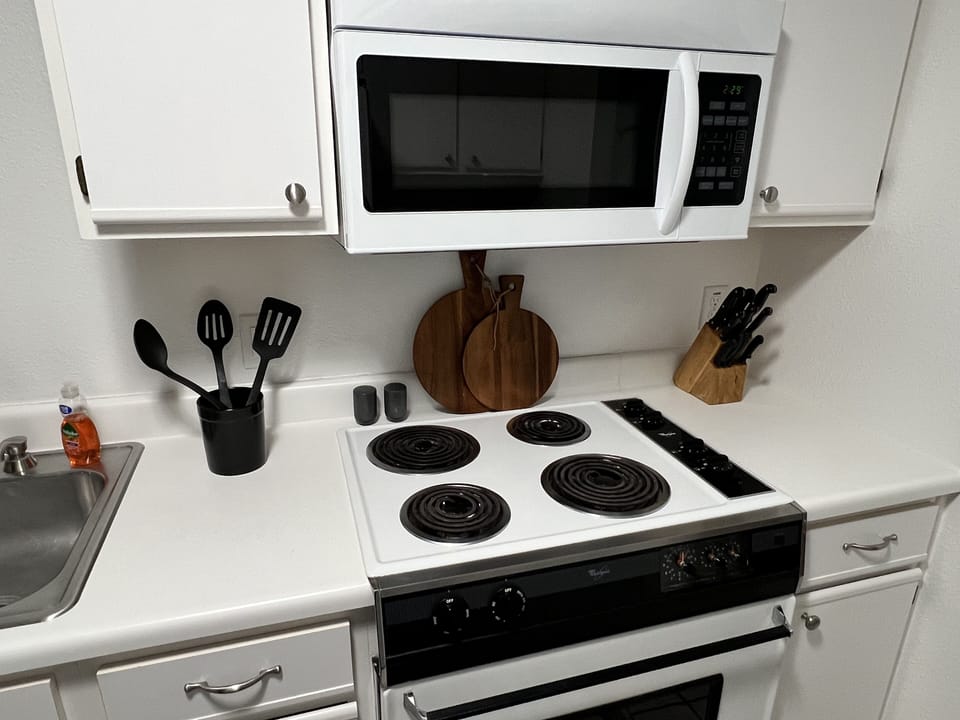 Electric stove with oven and over the range microwave.